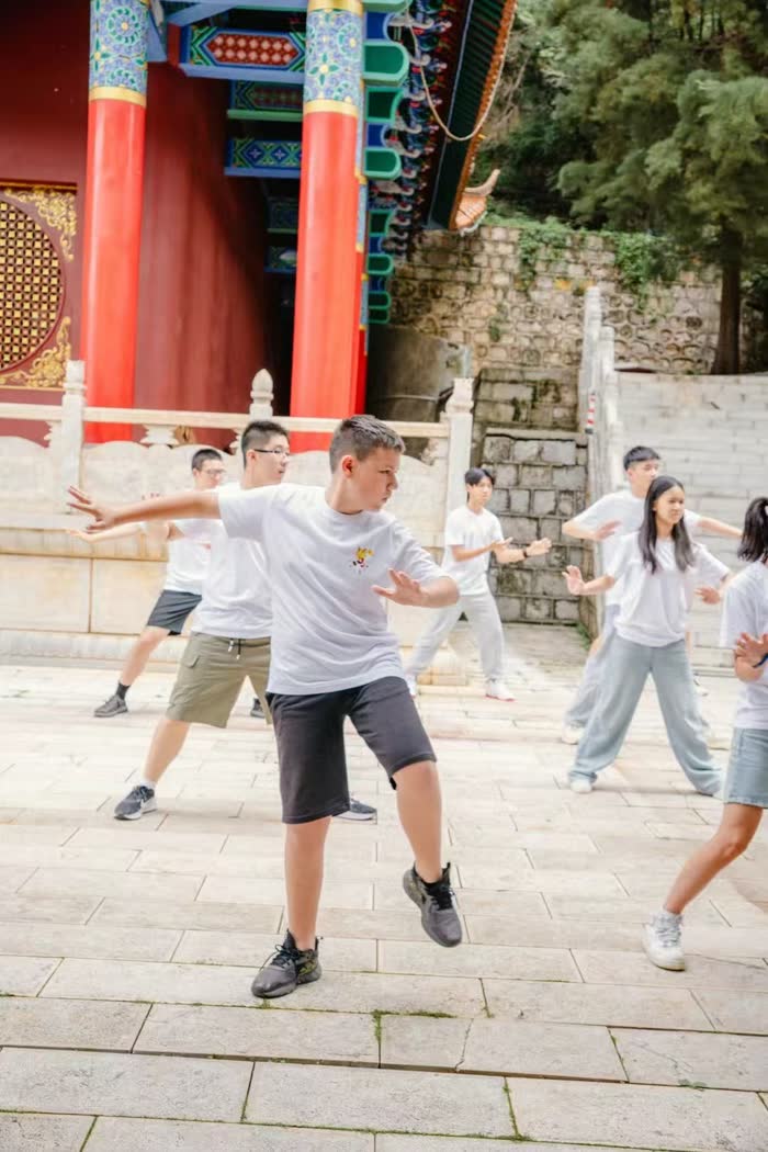 Uczestnicy obozu ćwiczą tai chi przed chińską świątynią — Centrum Studiów za Granicą